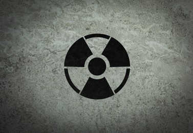 Image of Radioactive sign on grey stone wall. Hazard symbol