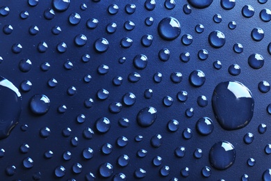 Water drops on dark background, top view