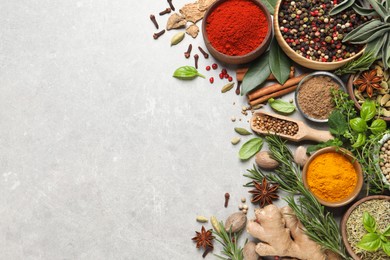 Photo of Different herbs and spices on grey table, flat lay. Space for text