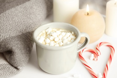 Composition with cup of hot winter drink on table. Cozy season