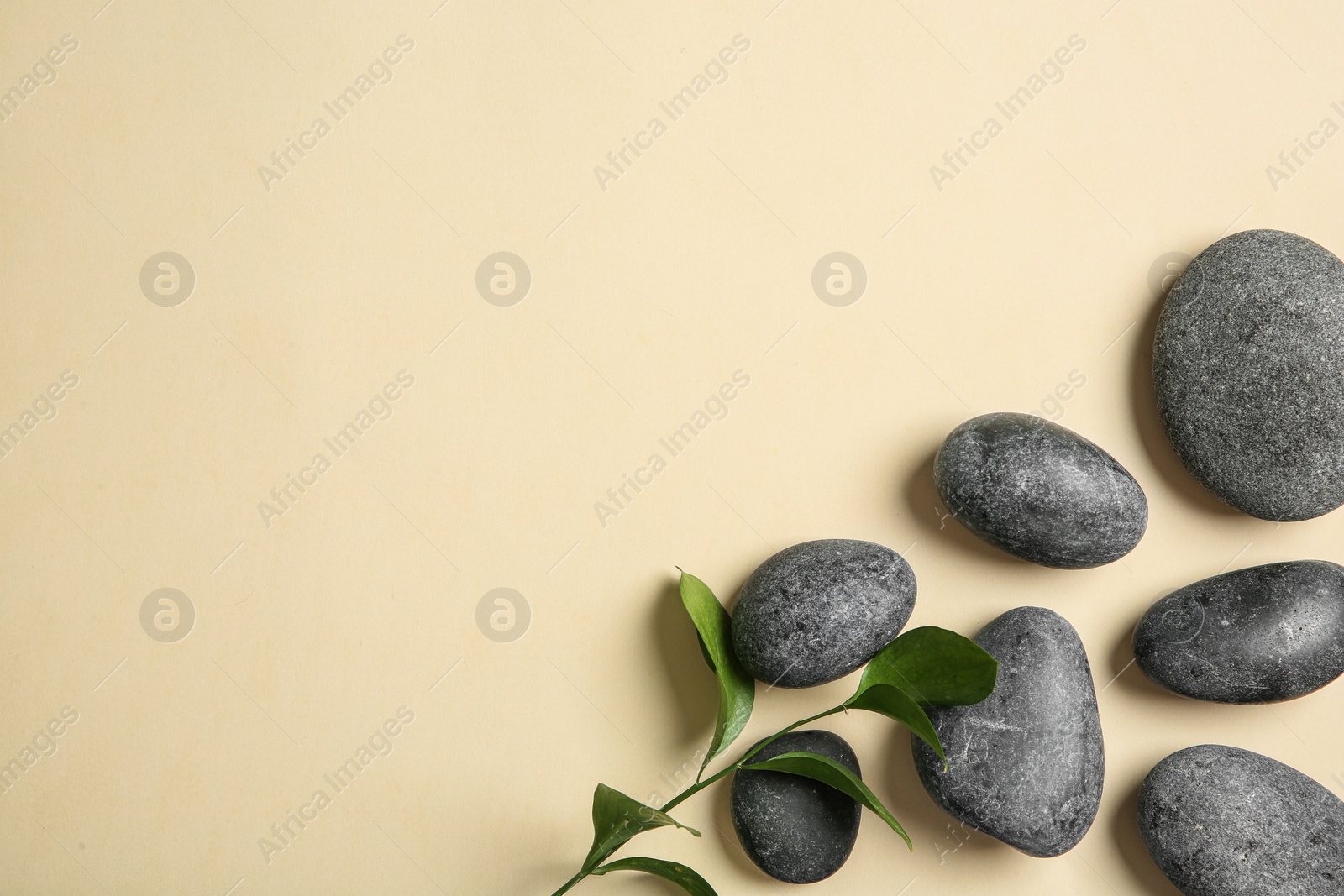 Photo of Flat lay composition with spa stones and space for text on color background