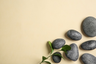 Photo of Flat lay composition with spa stones and space for text on color background