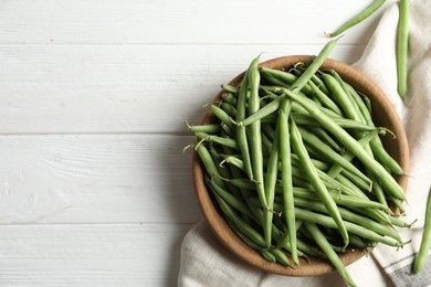 Photo of Fresh green beans on white wooden table, flat lay. Space for text