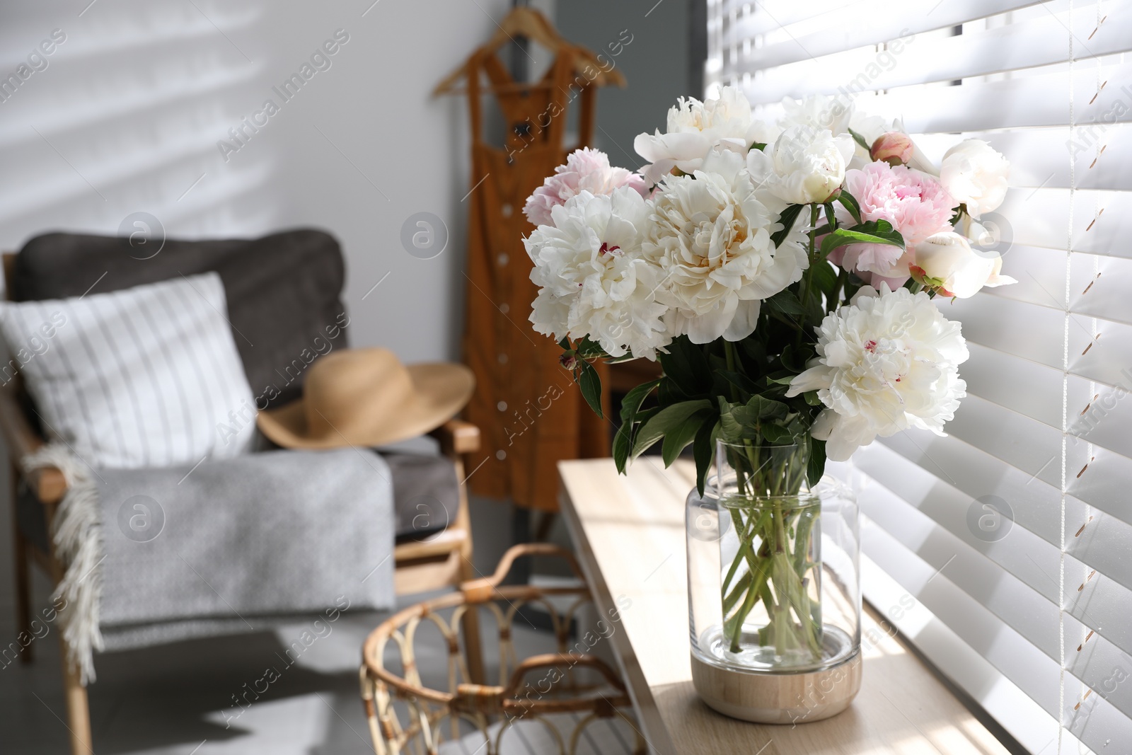 Photo of Bouquet of beautiful peony flowers on window sill indoors. Space for text