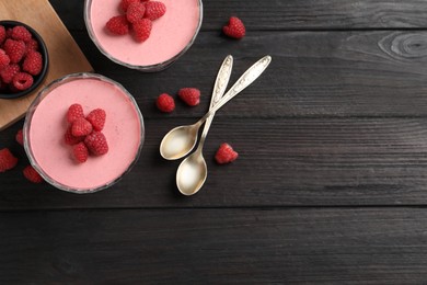 Photo of Delicious raspberry mousse on black wooden table, flat lay. Space for text
