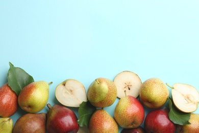 Ripe juicy pears on blue background, flat lay. Space for text