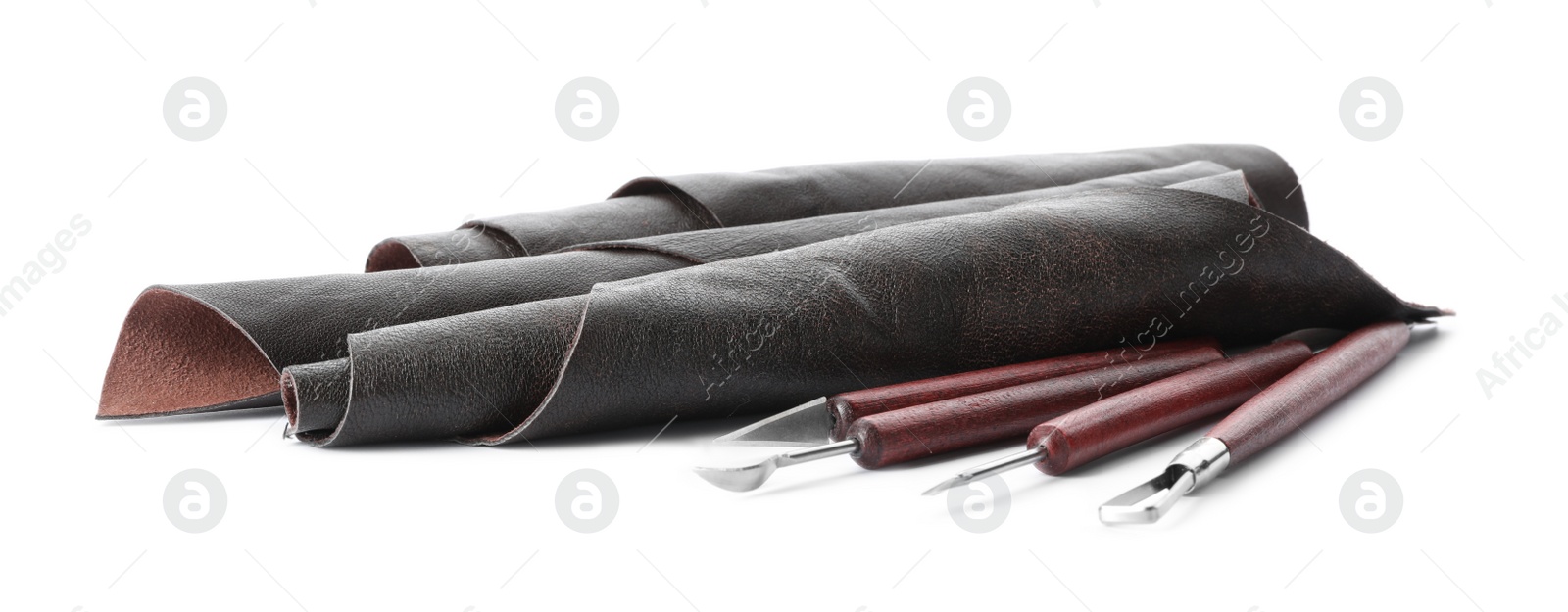 Photo of Leather samples and craftsman tools isolated on white