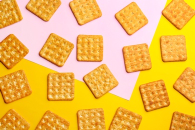 Delicious crackers on color background, flat lay