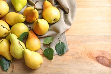 Ripe pears on wooden background, top view. Space for text