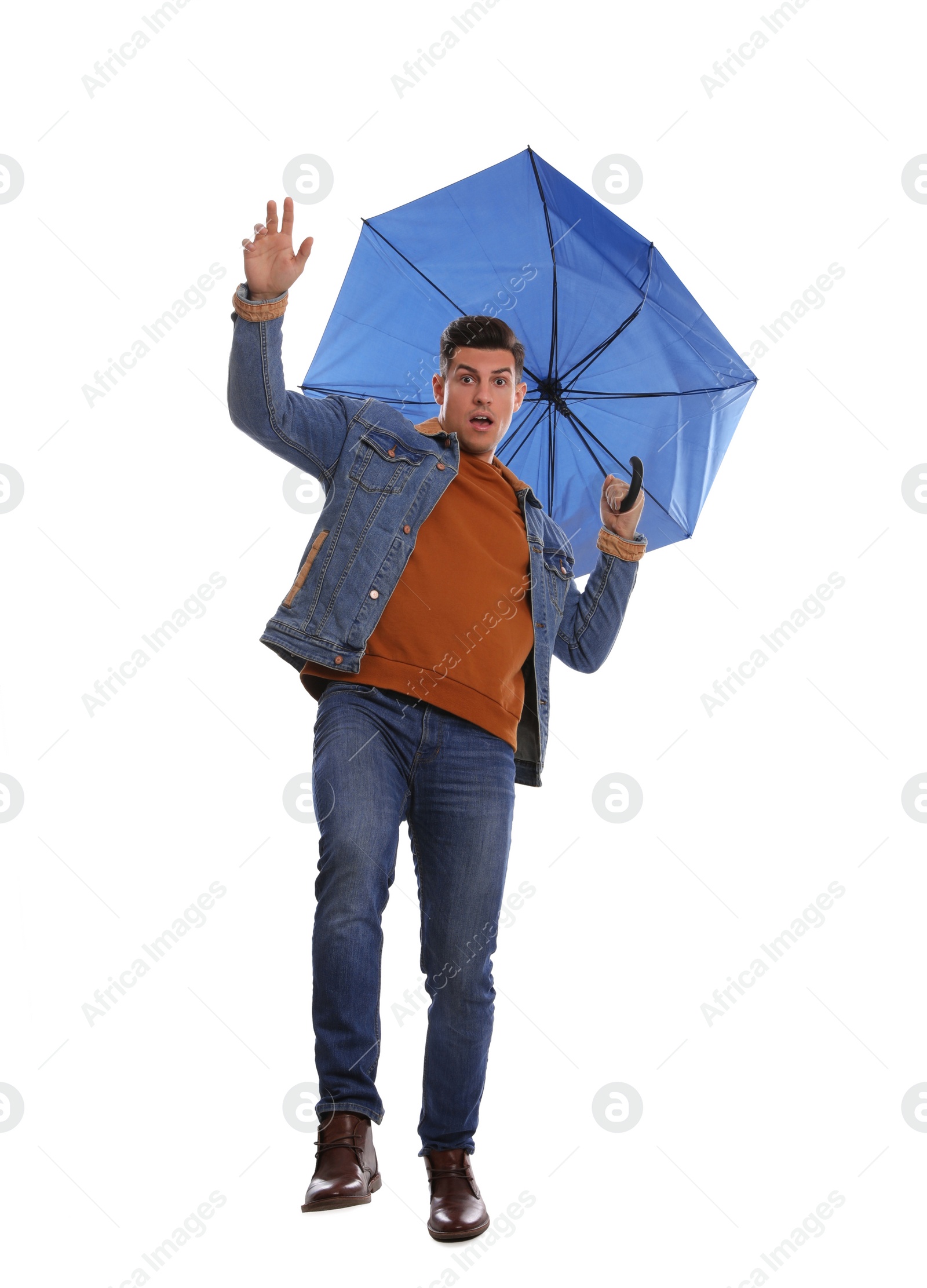 Photo of Emotional man with umbrella caught in gust of wind on white background