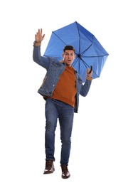 Emotional man with umbrella caught in gust of wind on white background