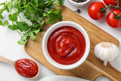 Photo of Flat lay composition with tomato sauce on white table