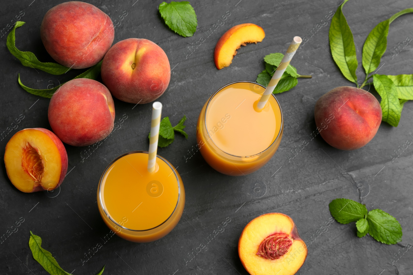 Photo of Natural freshly made peach juice on grey table, flat lay