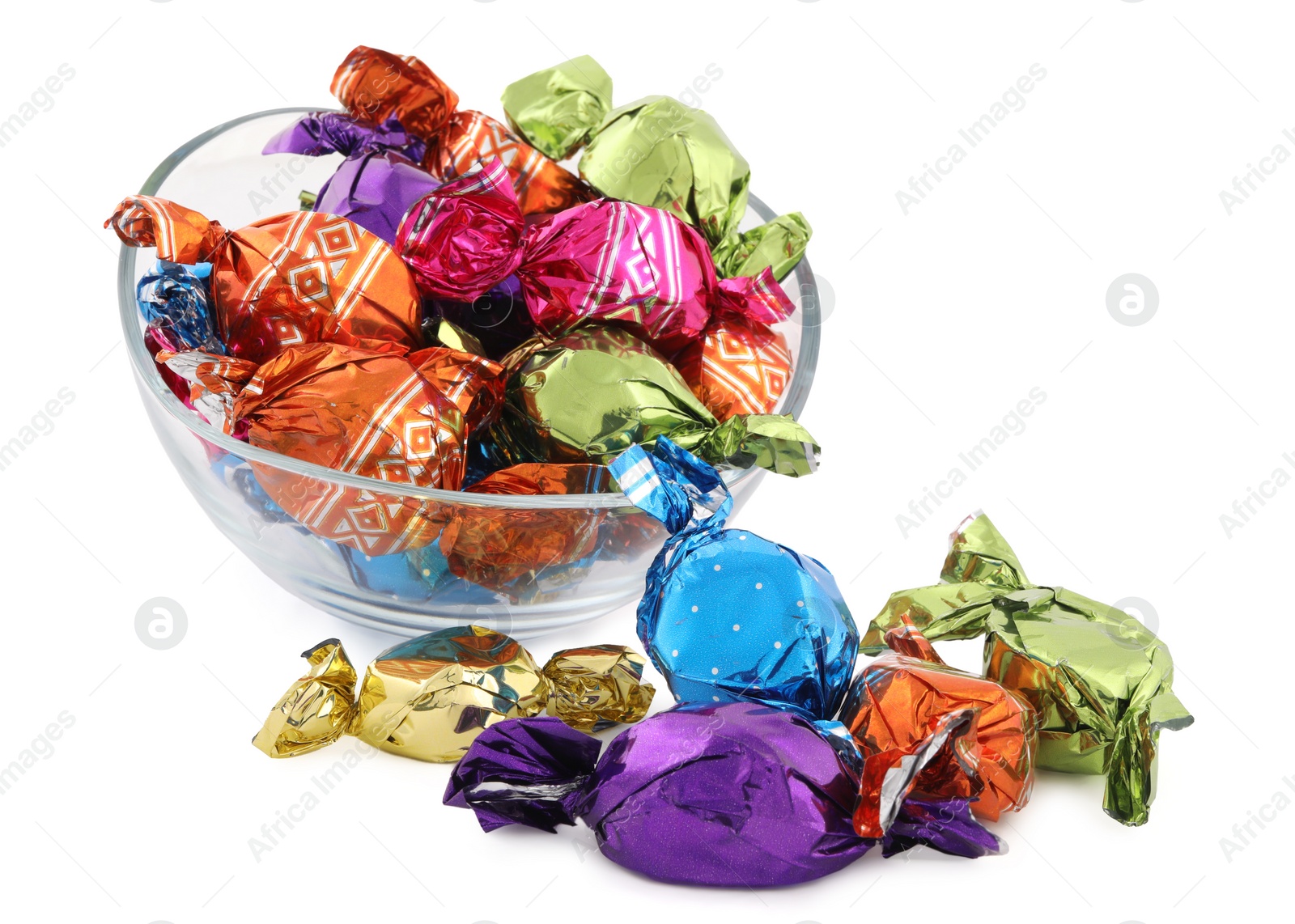 Photo of Bowl with sweet candies in colorful wrappers on white background