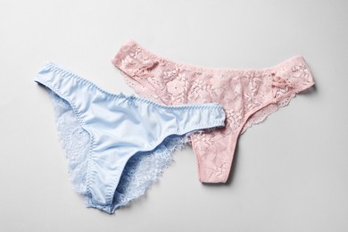 Photo of Women's underwear on light grey background, flat lay