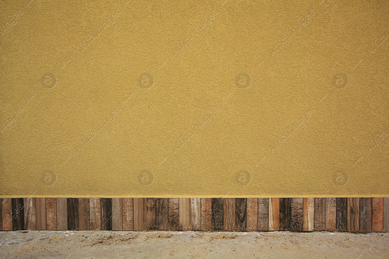 Photo of Beautiful yellow textured wall and concrete floor