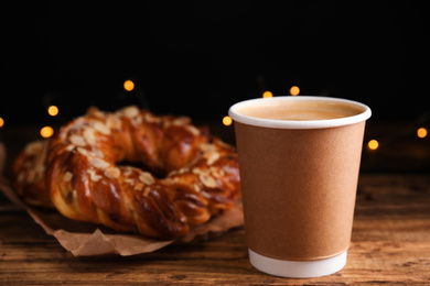 Photo of Delicious coffee and pastries on wooden table