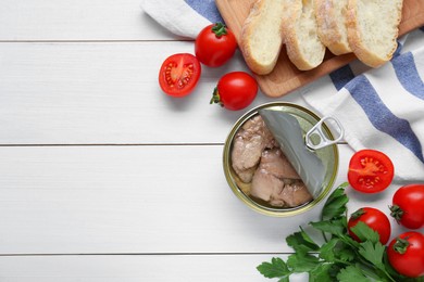 Photo of Flat lay composition with tin can of tasty cod liver and different products on white wooden table. Space for text