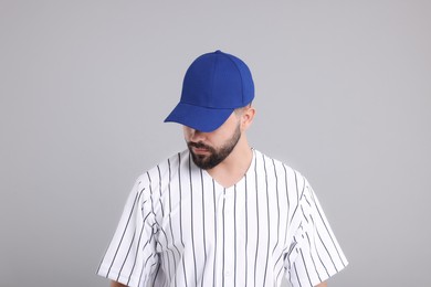 Photo of Man in stylish blue baseball cap on light grey background