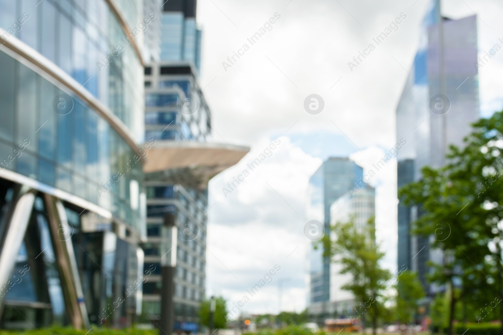 Photo of Beautiful buildings with many windows on cloudy day in city, blurred view