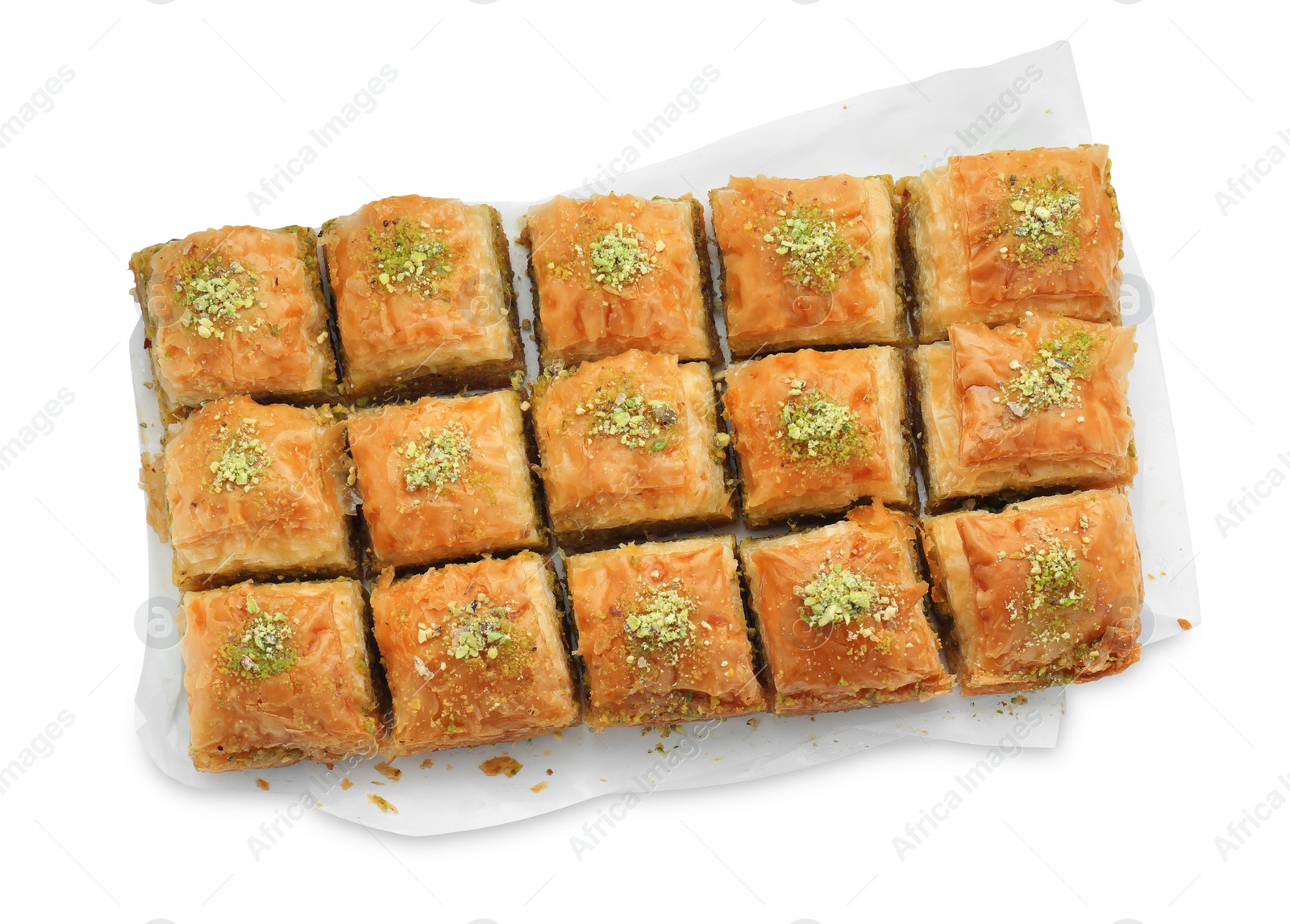 Photo of Delicious fresh baklava with chopped nuts isolated on white, top view. Eastern sweets