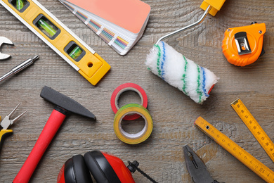 Flat lay composition with different construction tools on wooden background