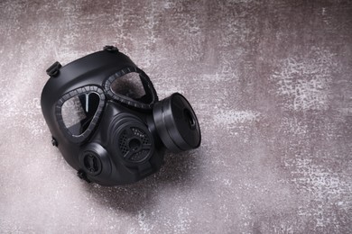 One gas mask on grey textured background, top view. Space for text