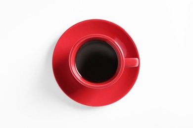 Red cup with aromatic coffee on white background, top view