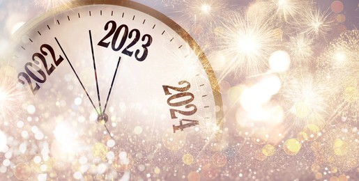 Image of Clock counting last moments to New 2023 Year and beautiful fireworks on background, banner design