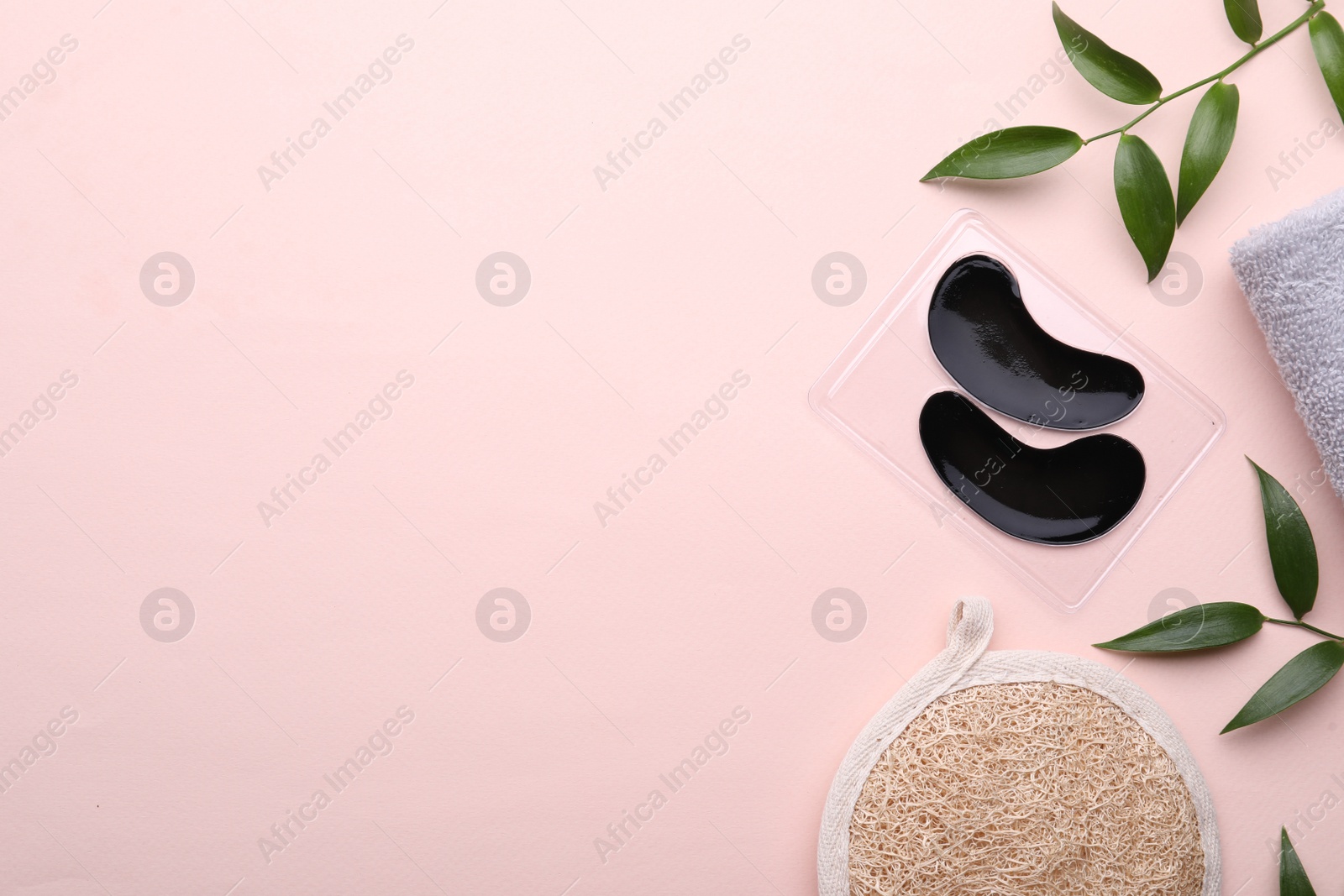 Photo of Flat lay composition with under eye patches on light pink background. Space for text