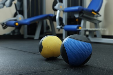 Photo of Medicine balls on floor in gym, space for text
