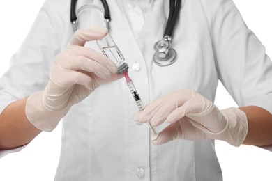 Photo of Doctor filling syringe with medication from glass vial on white background, closeup