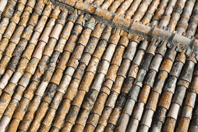 Above view of old roof tiles on sunny day as background