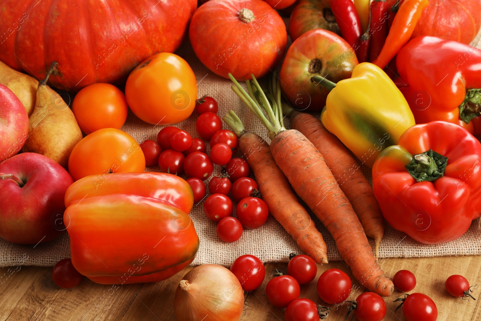 Photo of Different fresh ripe vegetables and fruits on wooden table, closeup