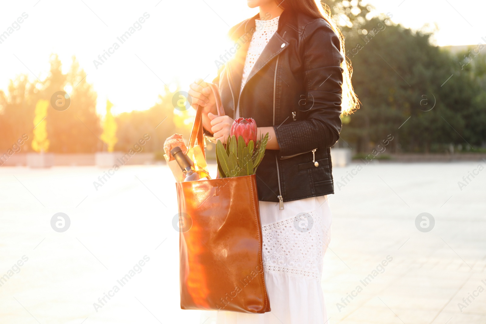 Photo of Woman with leather shopper bag on city street, closeup