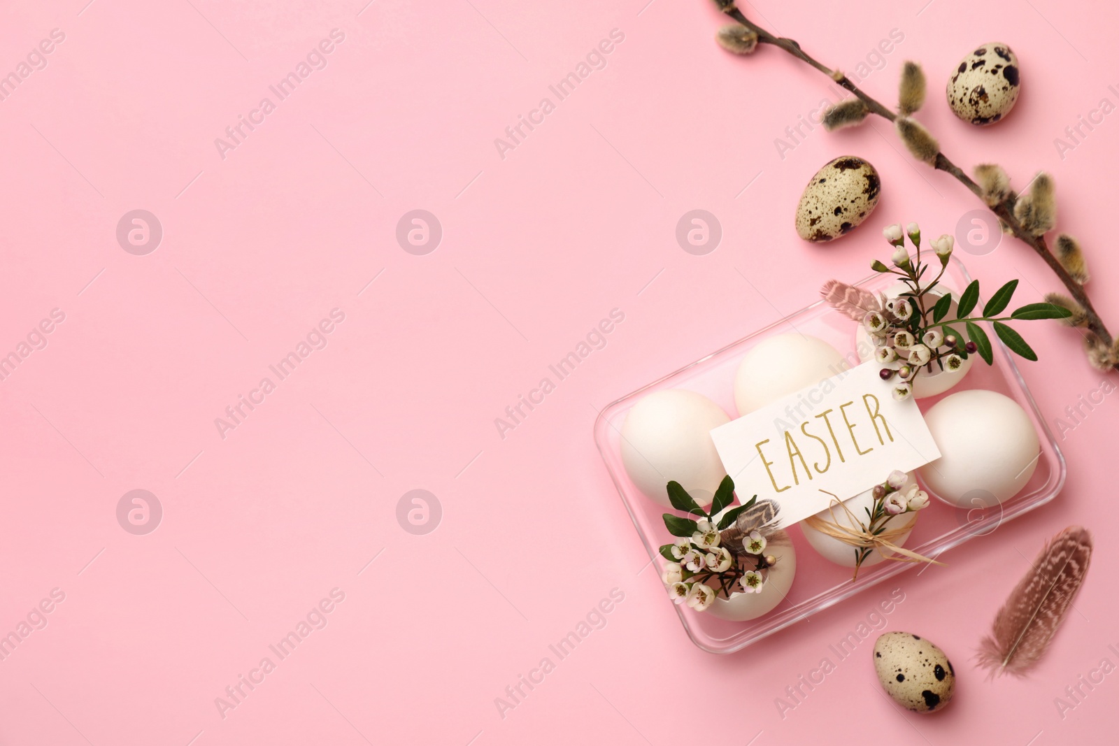 Photo of Flat lay composition with eggs, natural decor and word Easter on pink background. Space for text