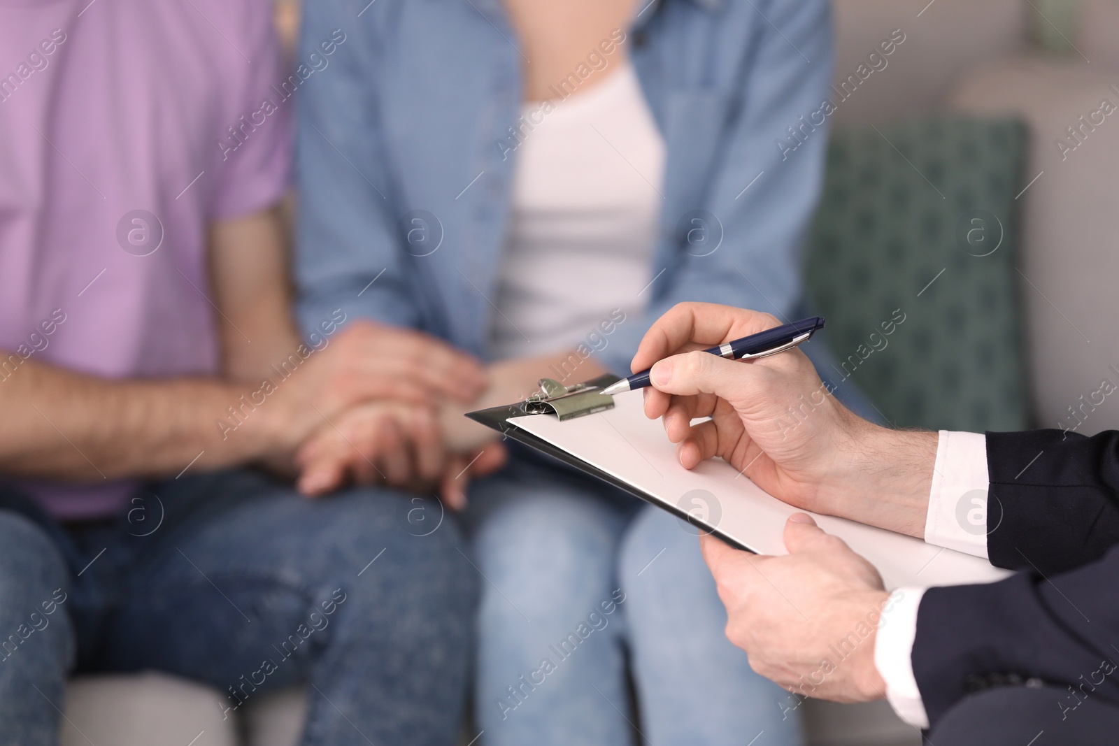 Photo of Family psychologist working with young couple in office, closeup