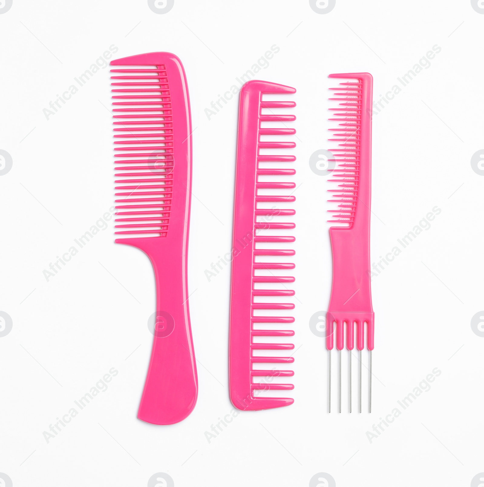 Photo of Pink hair combs on white background, top view