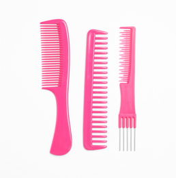 Photo of Pink hair combs on white background, top view