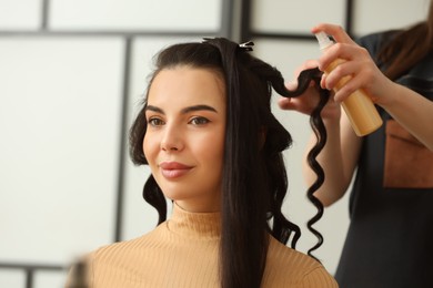 Photo of Hair styling. Professional hairdresser working with client in salon, closeup