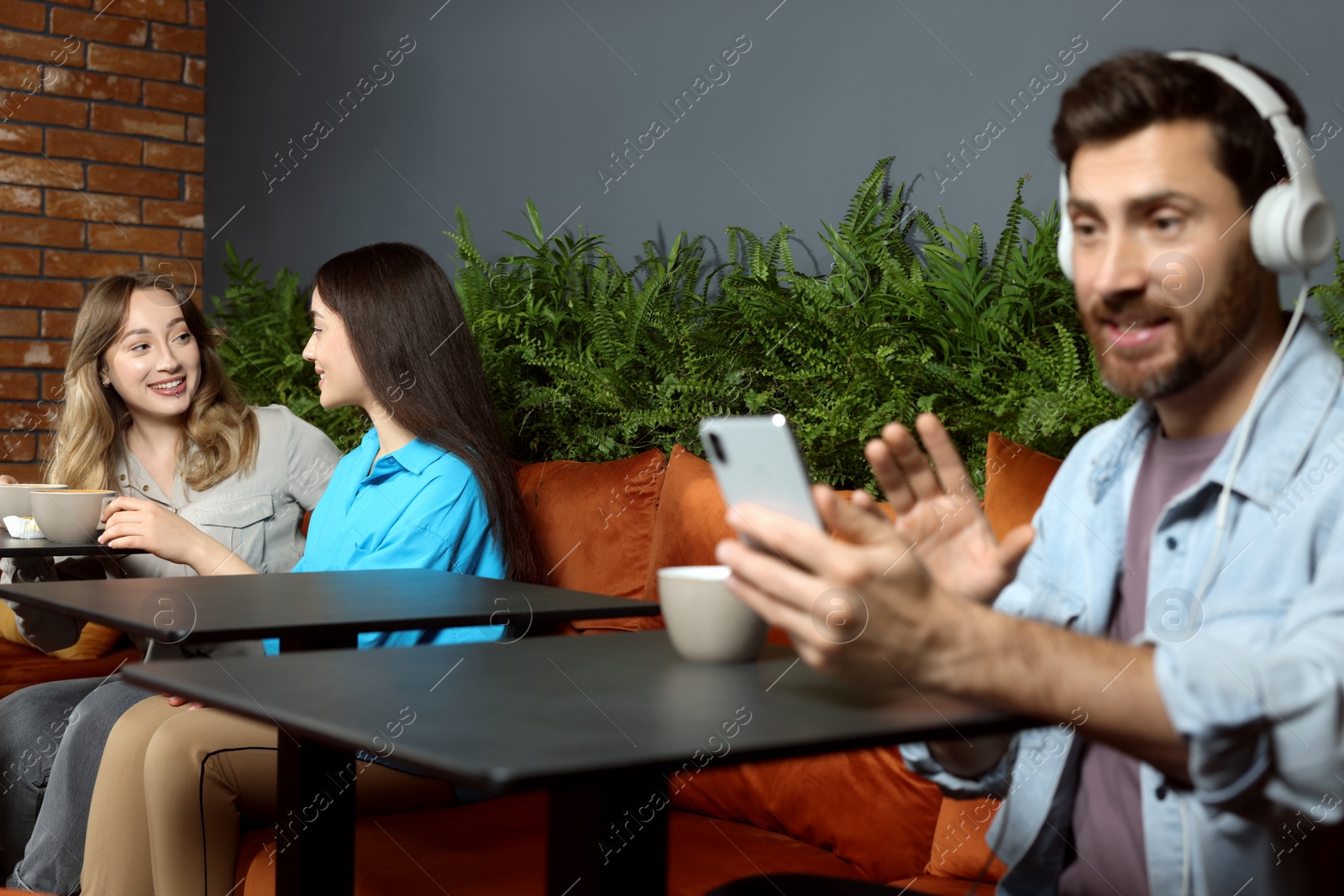 Photo of People with coffee spending time in cafe