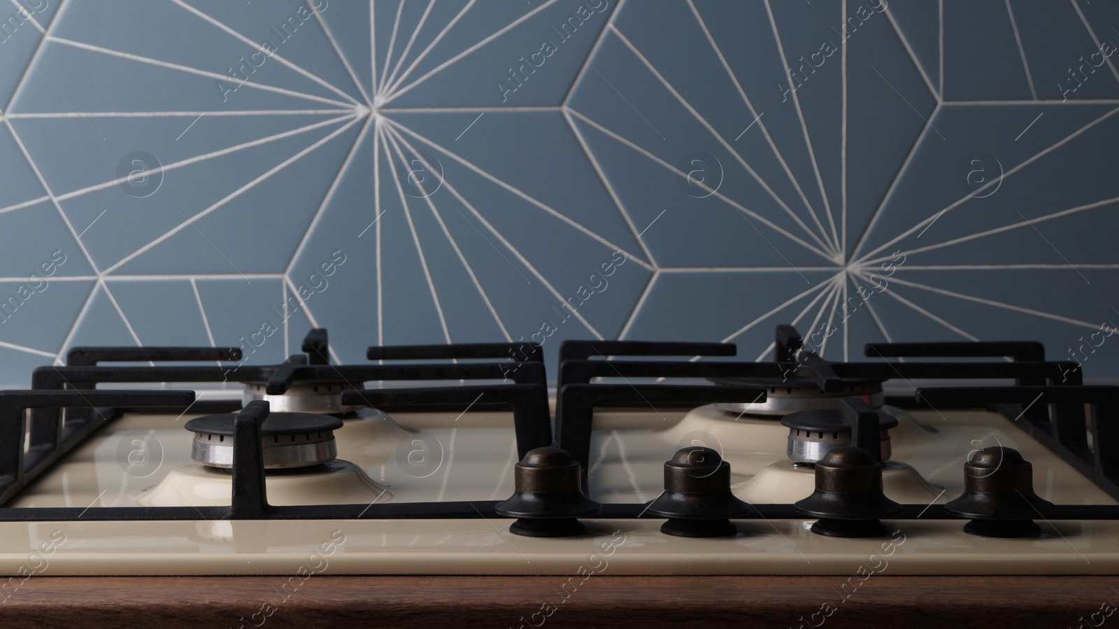 Photo of Modern gas cooktop in kitchen, closeup. Cooking appliance