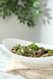 Photo of Delicious salad with beef tongue, arugula and seeds on white marble table