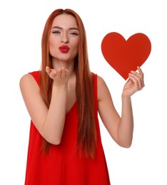 Photo of Young woman in red dress with paper heart blowing kiss on white background