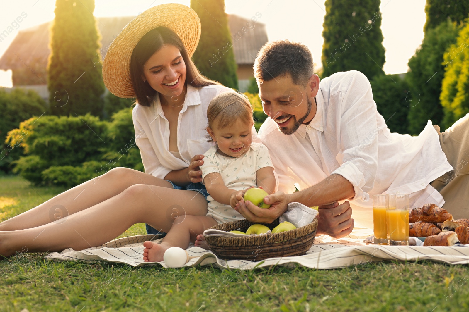 Photo of Happy family having picnic in garden on sunny day