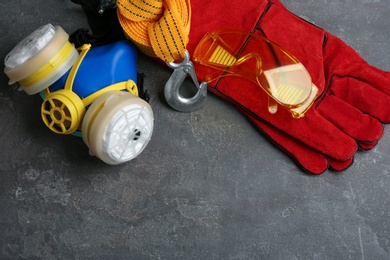 Photo of Flat lay composition with safety equipment and space for text on grey background