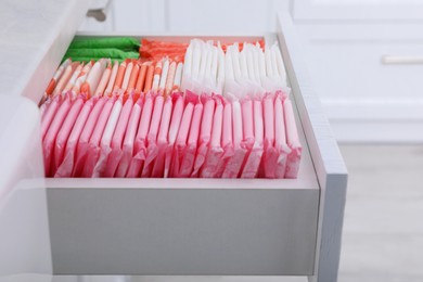 Photo of Storage of different feminine hygiene products in drawer indoors
