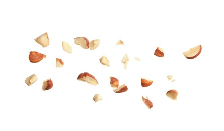 Photo of Pieces of tasty hazelnuts on white background