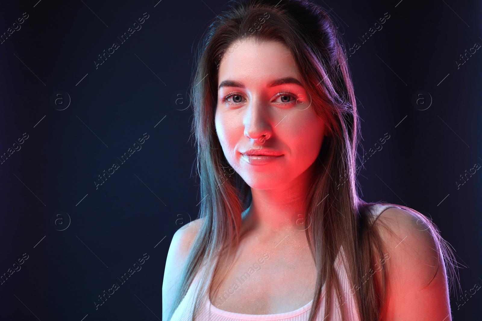 Photo of Portrait of beautiful young woman on color background, space for text