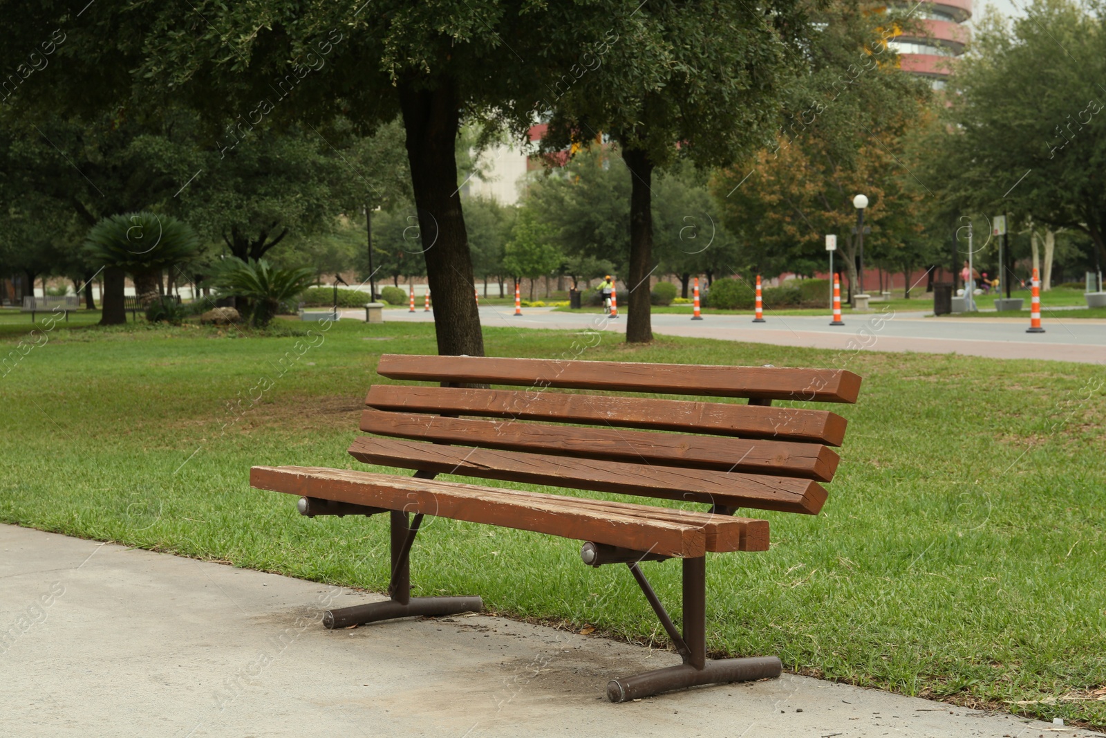 Photo of Stylish wooden bench in park on sunny day